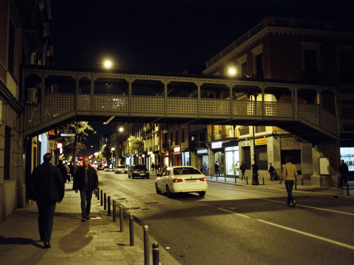 Late Night Madrid Street Scene with Pedestrian Overpass and Wet Footsteps in in Madrid, Spain