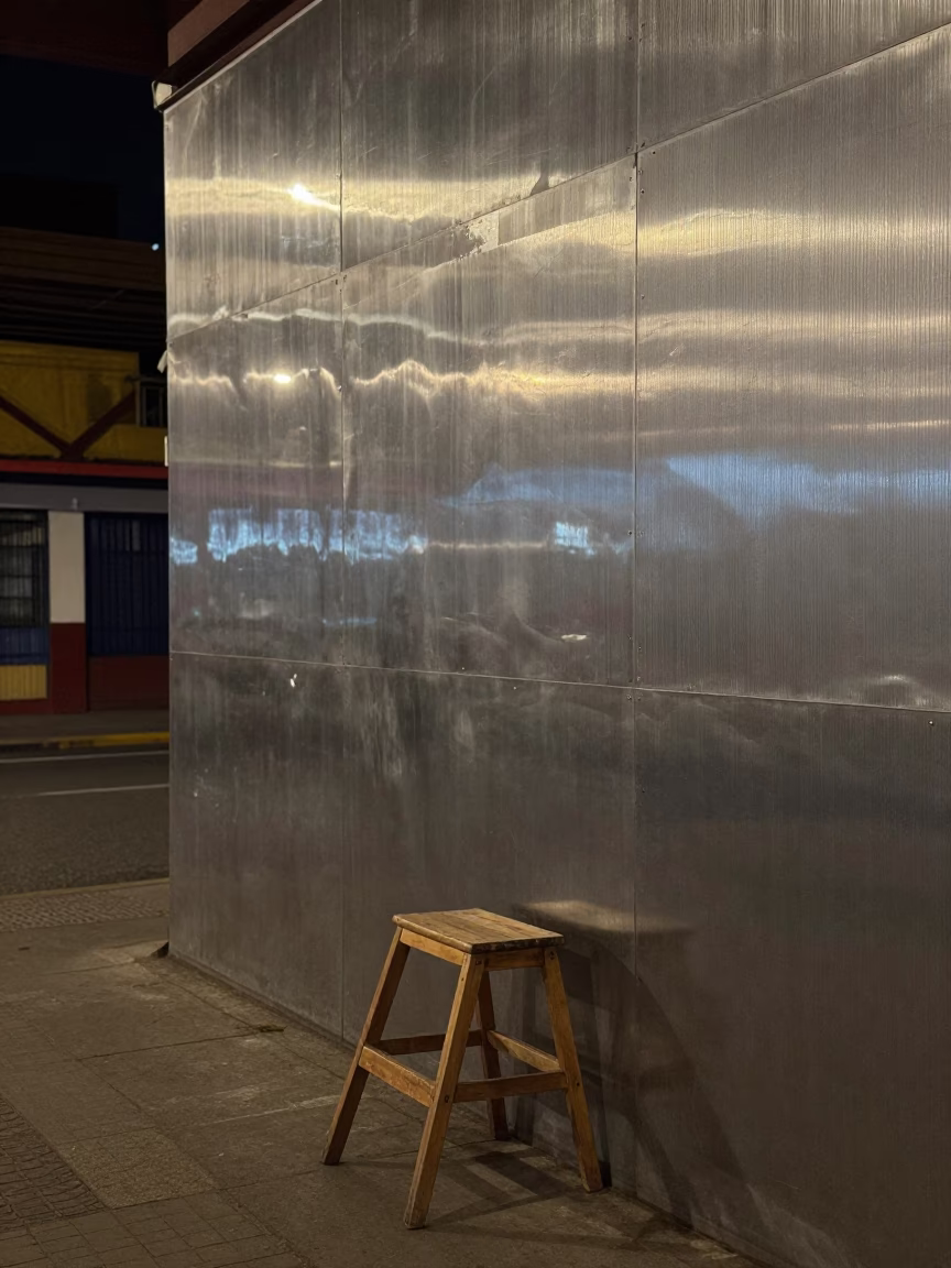 Late Night Medellin Street Scene with Brushed Steel Wall and Step Stools in in Medellin, Colombia