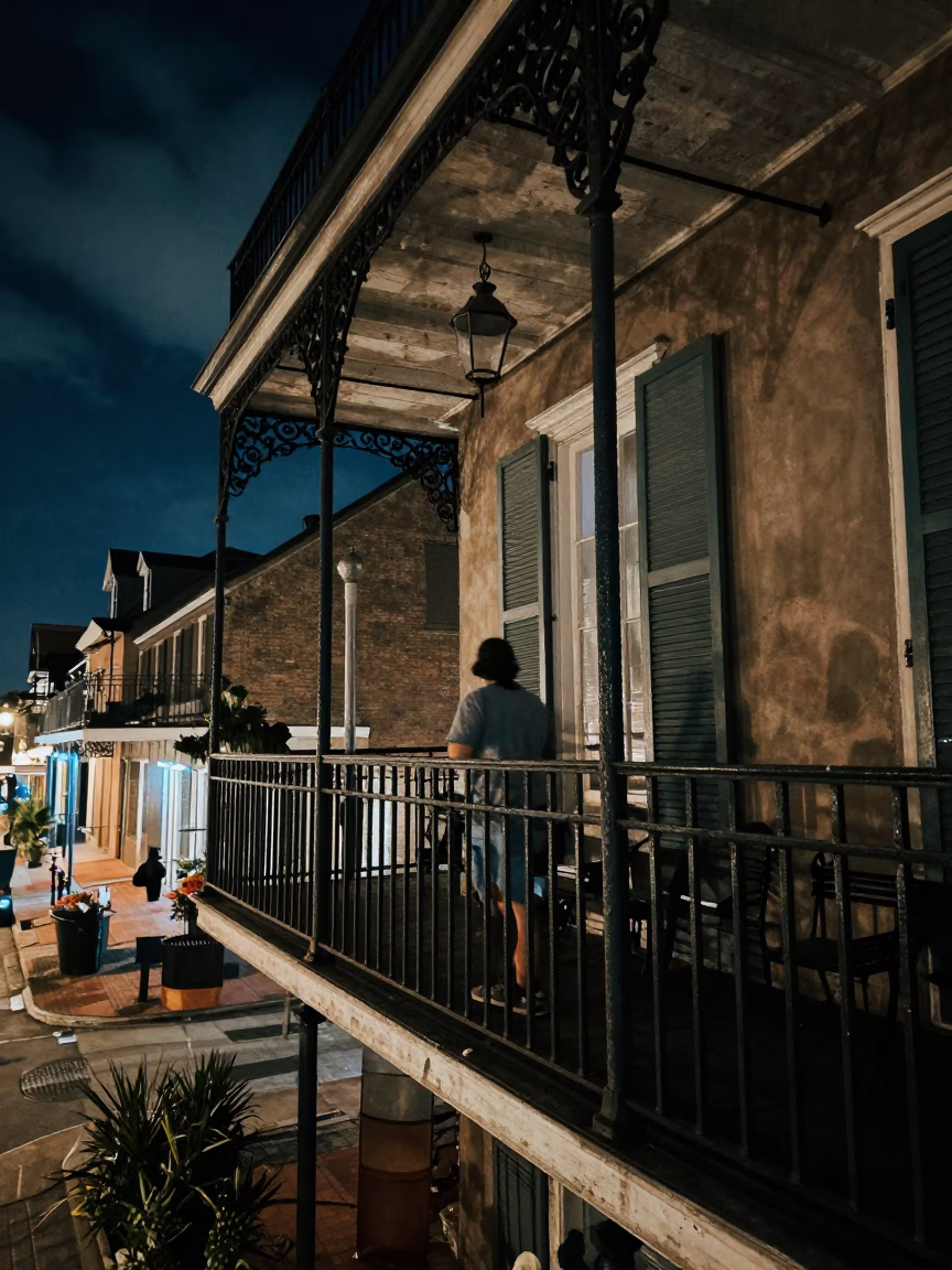 Late Night New Orleans Balcony Scene with Iron Railings and City Lights in in New Orleans, Louisiana, United States