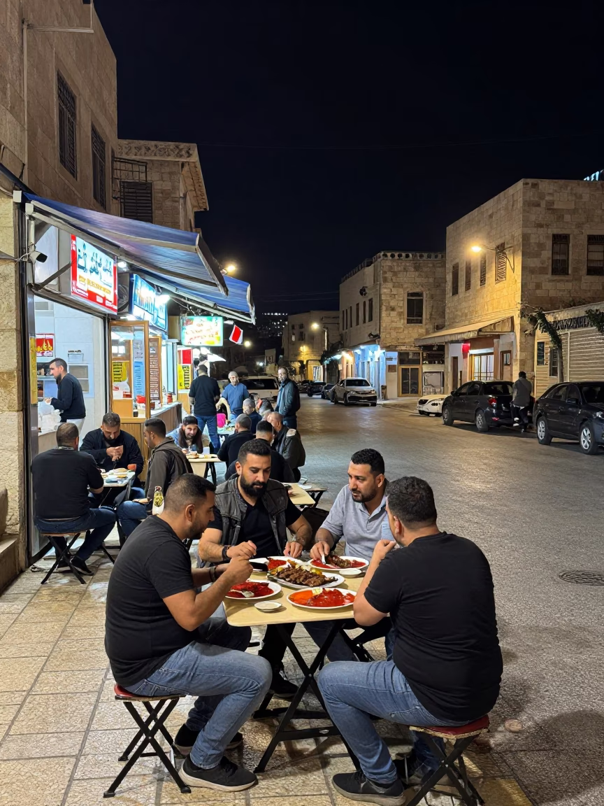 Late Night Street Scene in Amman Jordan with Local Dining and Folding Stools in in Amman, Jordan