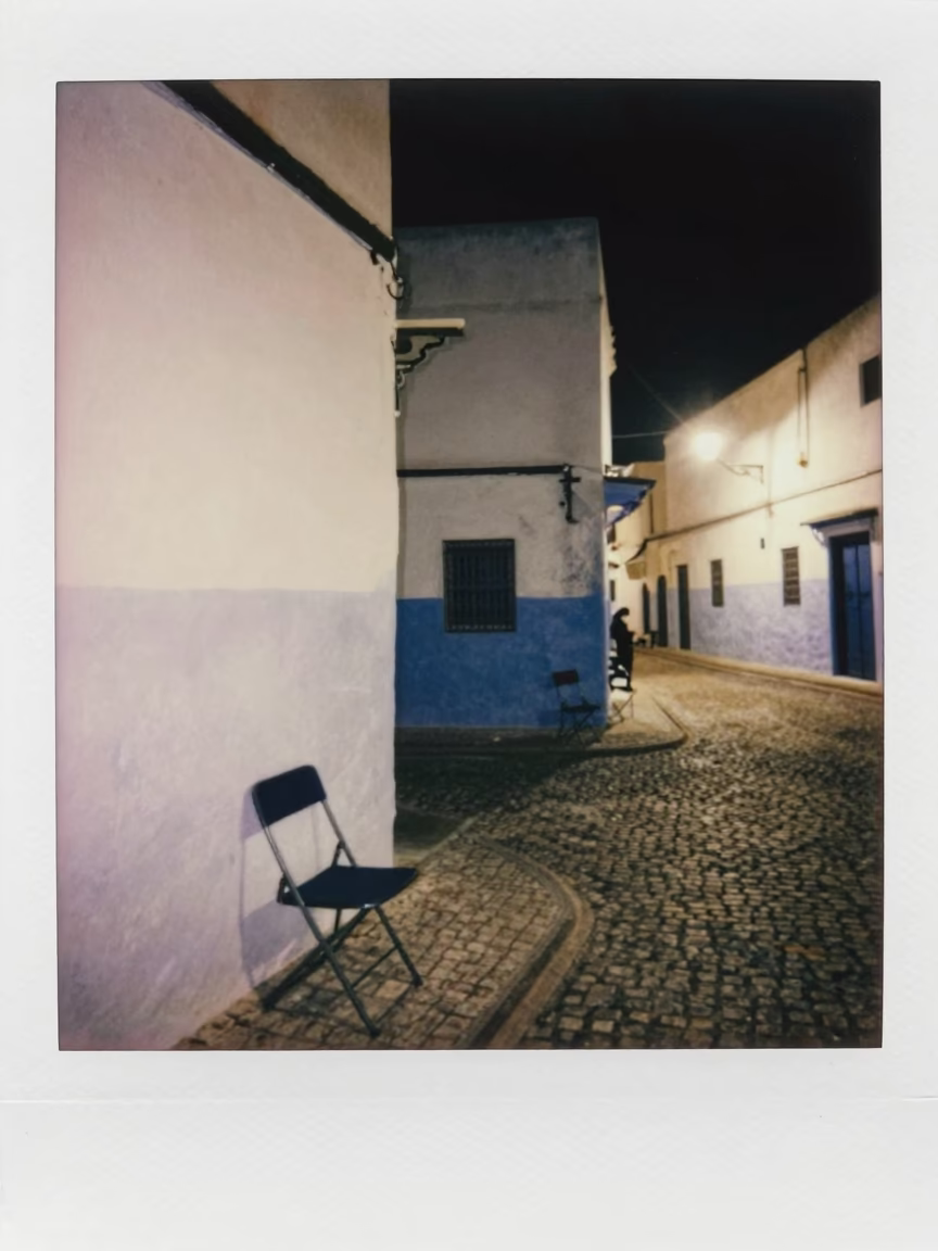 Late Night Street Scene in Essaouira Morocco with Folding Chair and Tea Stains in in Essaouira, Morocco