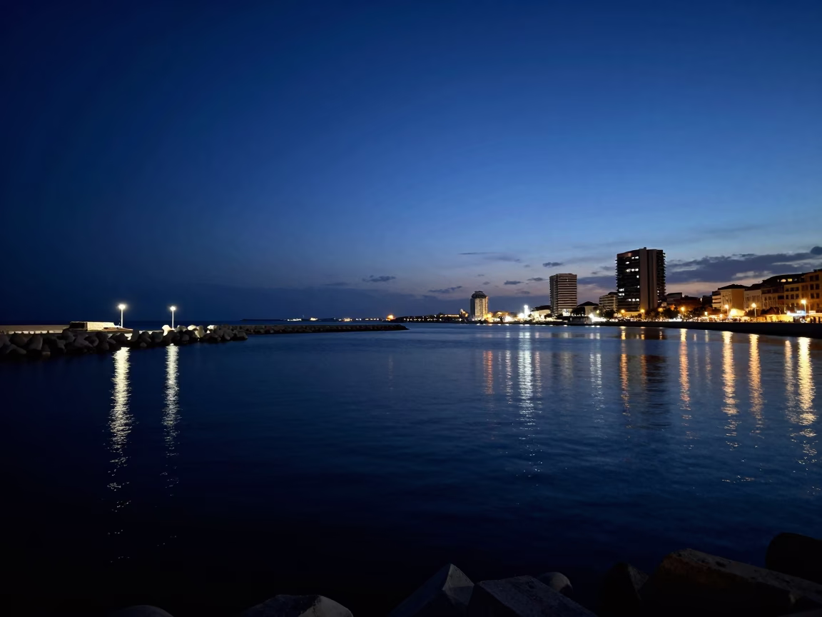 Late Night Valencia Harbor Breakwater with Fading Blue Hour Sky and Orange Peel in in Valencia, Spain