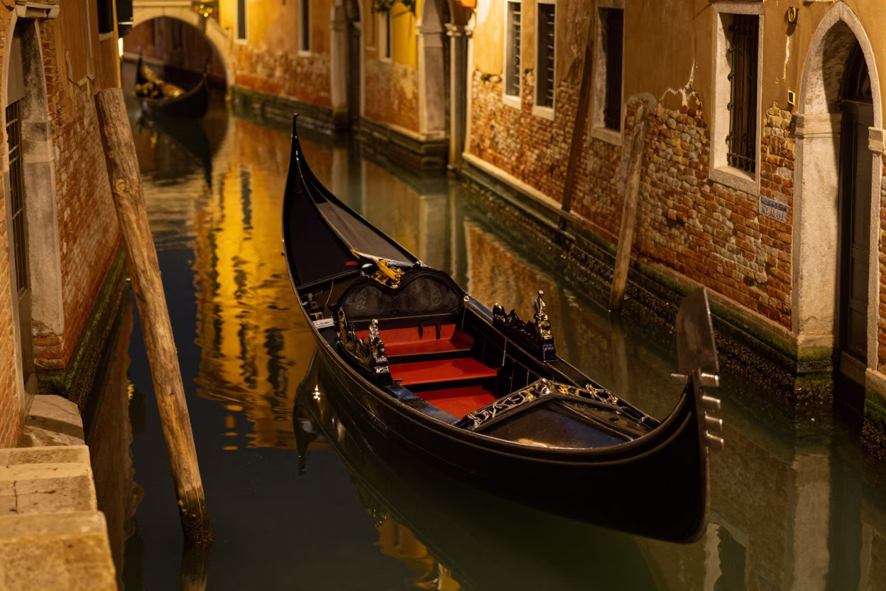 Late Night Venetian Canal Reflections and Empty Gondola Docked at Stone Pier in in Venice, Italy