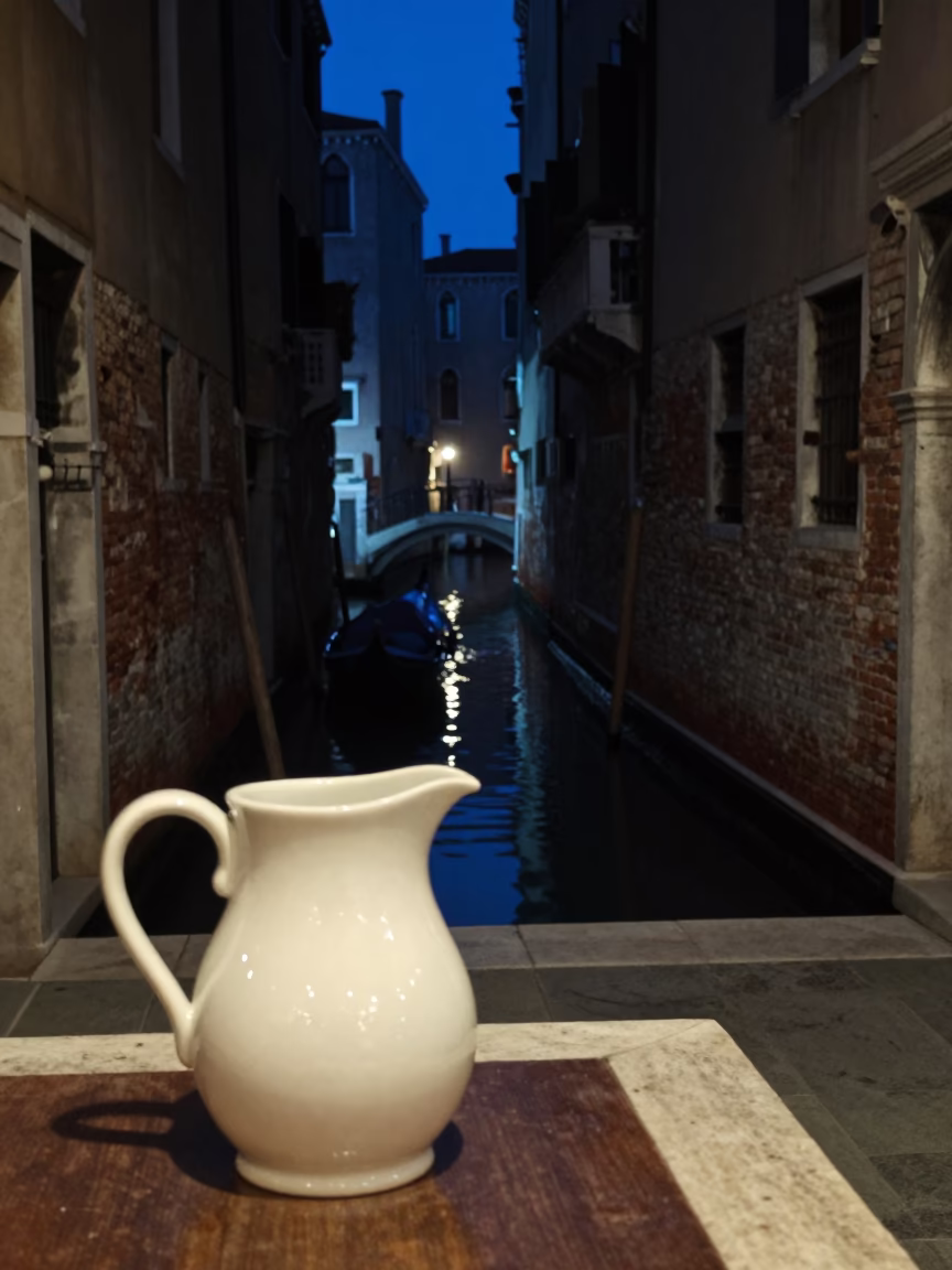 Late Night Venice Street Scene with Ceramic Pitcher and Canal Reflections in in Venice, Italy