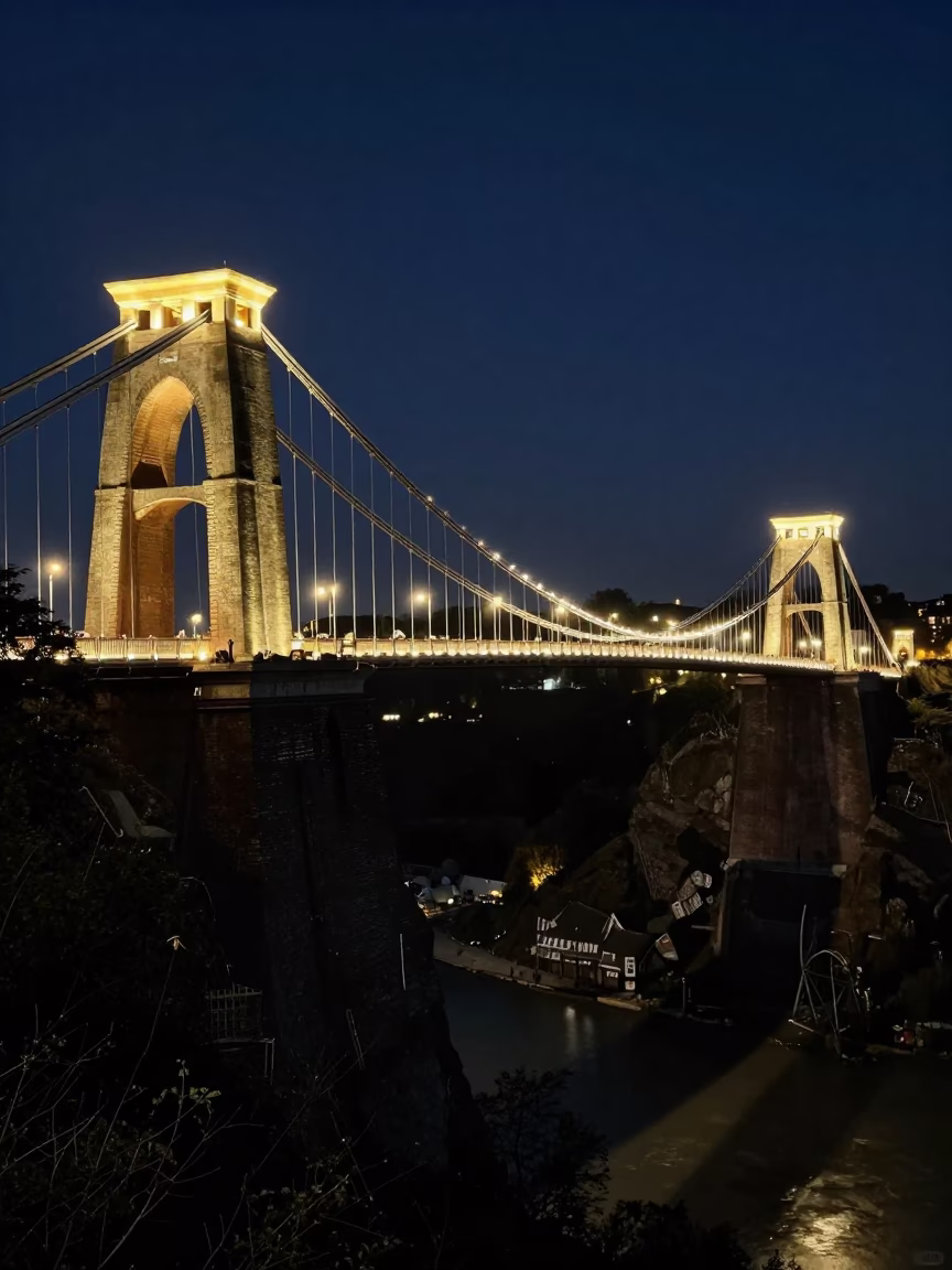Late Night View of Clifton Suspension Bridge Illuminated Over Dark Harbor in Bristol UK in in Bristol, United Kingdom
