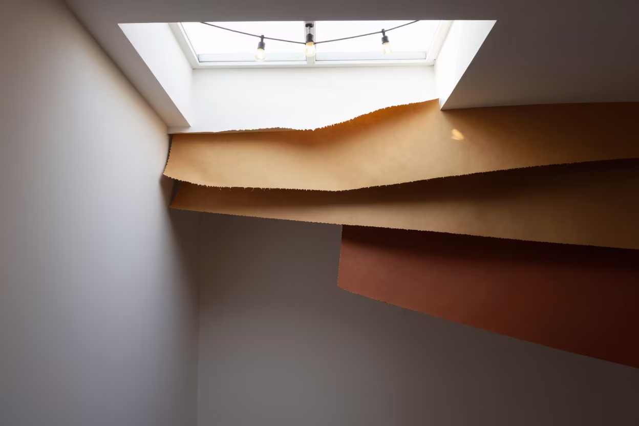 Layered Torn Paper in Warm Hues in inside a skylit passageway near Bucharest