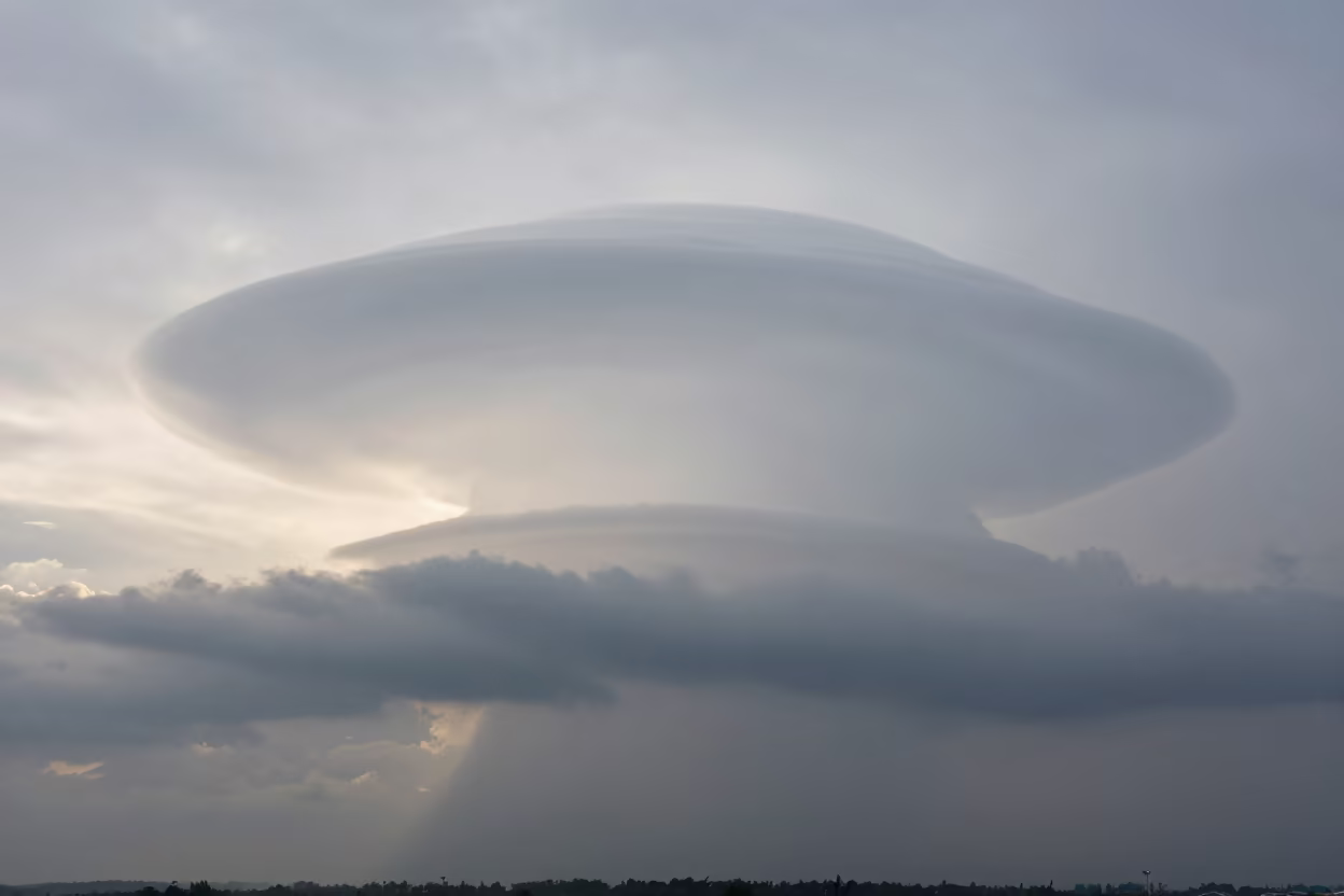 Lenticular Cloud Stack Over Guangdong Thunderheads at Dawn in over a horizon of stacked thunderheads in Guangdong