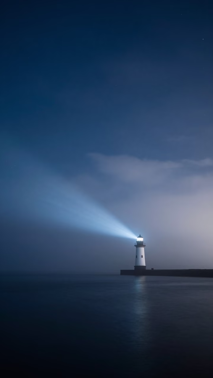 Lighthouse Beam Sweeping Through Predawn Fog in beneath thin cloud gaps and stars near Ensenada