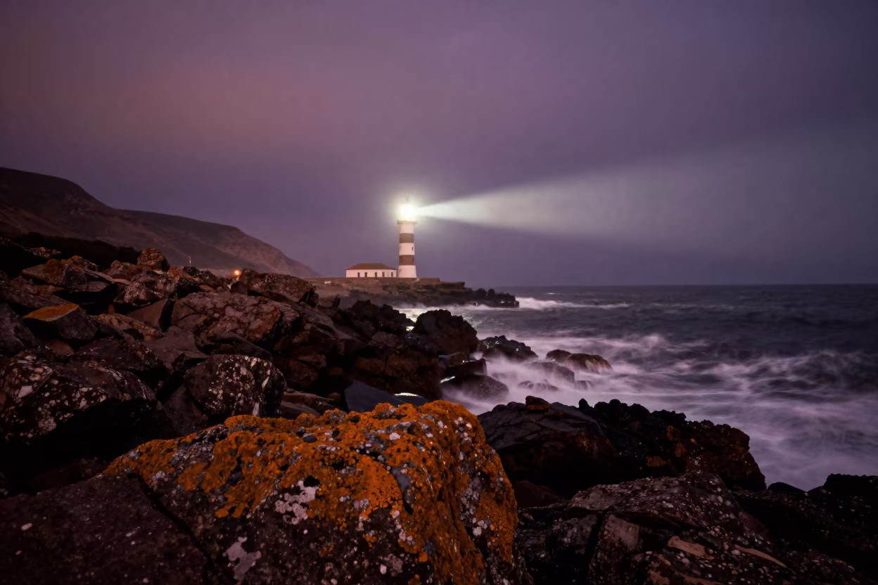 Lighthouse Beam Sweeps Atlantic Coast Near Mellah in from a ridge above layered foothills near Mellah, Essaouira