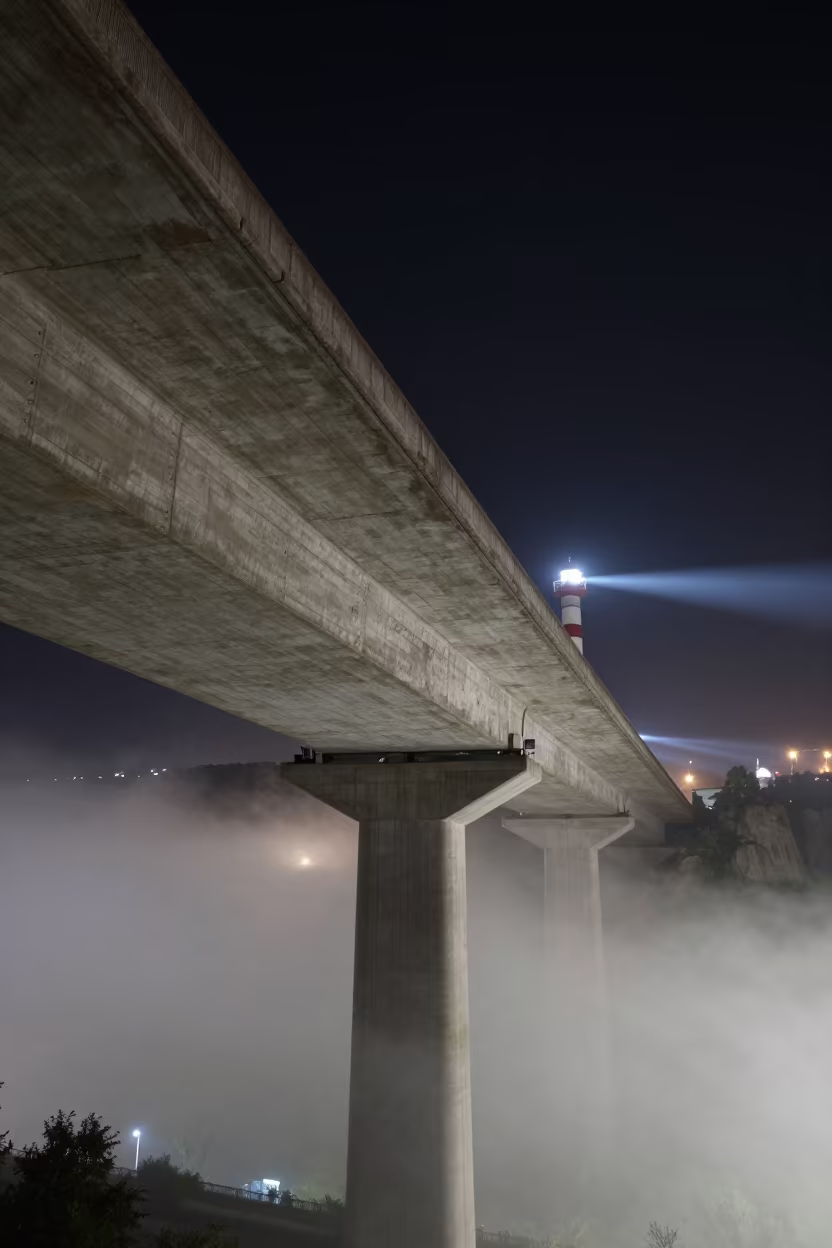 Lighthouse Beam Sweeps Tbilisi Viaduct at Night in beneath a bridge span in Tbilisi