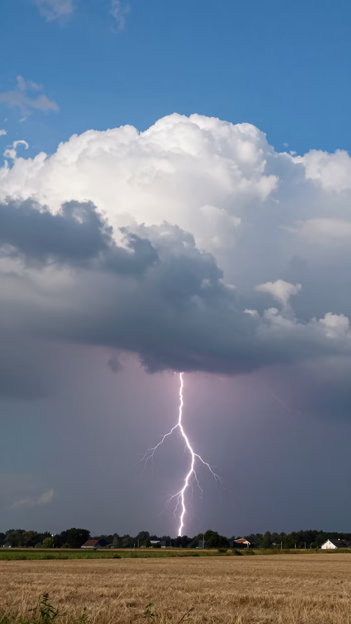 Lightning Crawling Under Storm Clouds in over a horizon of stacked thunderheads in Netherlands
