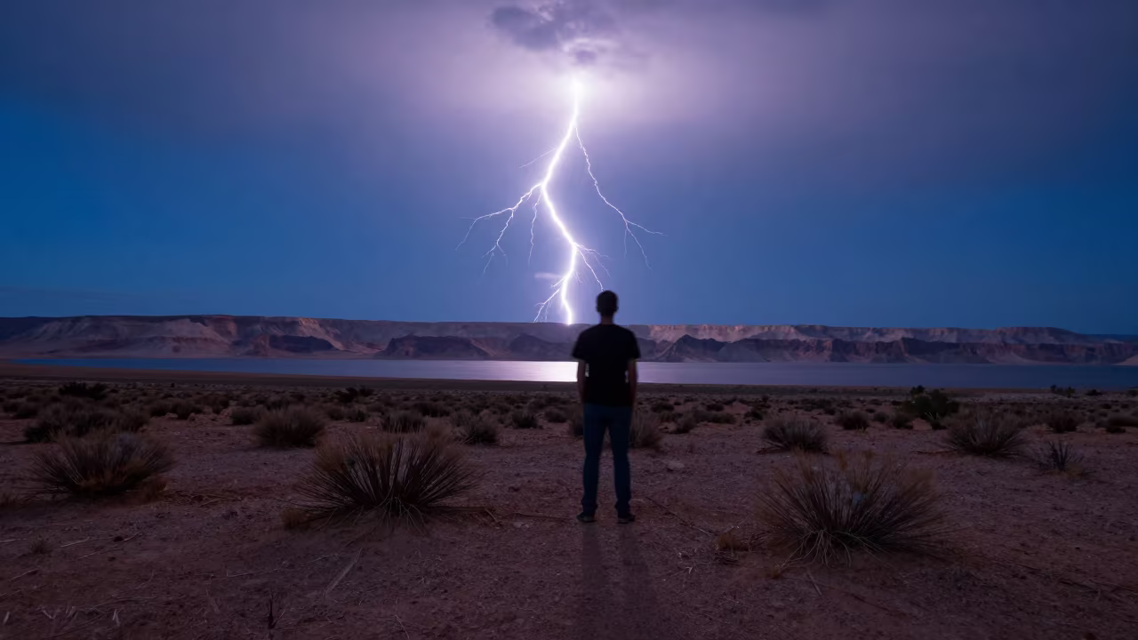 Lightning Forks Over Nevada Desert Mesa in across a storm-bright plain in Nevada