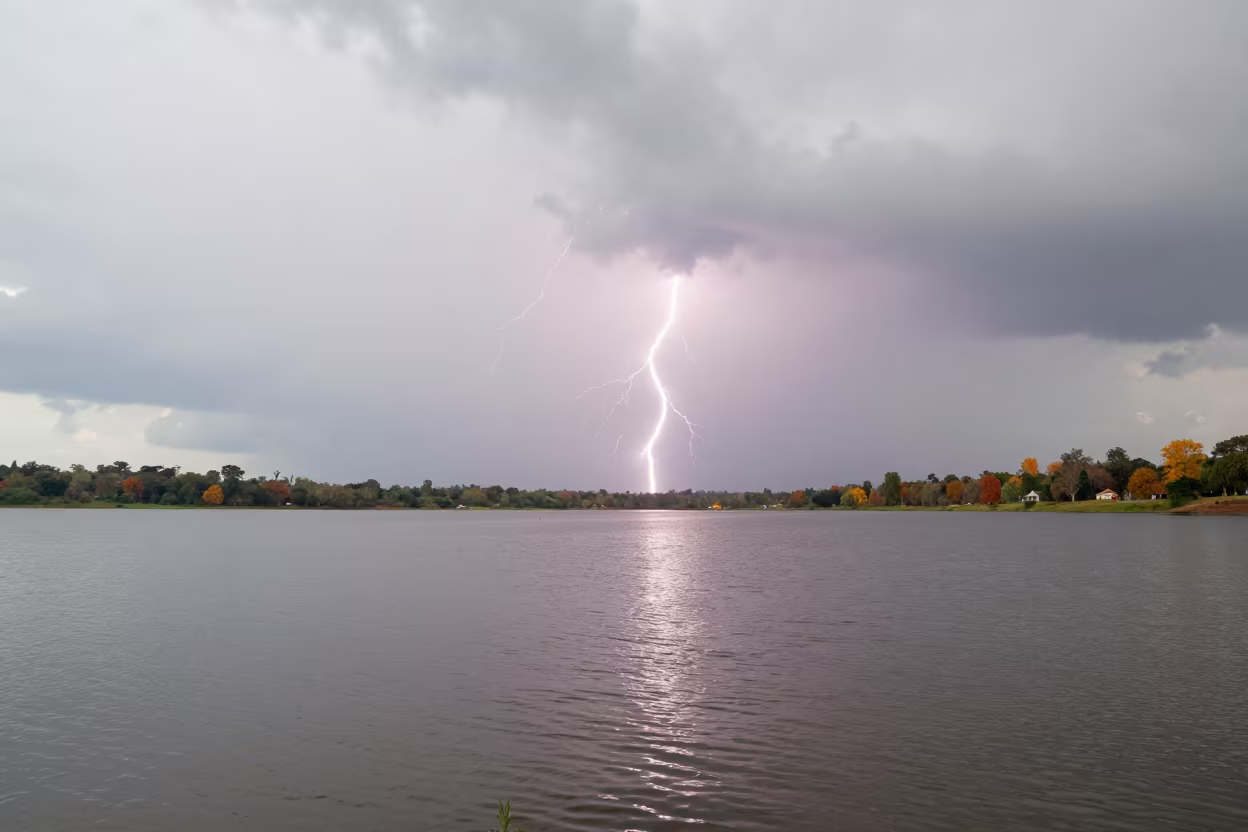 Lightning Over Rippled Lake Near Mbanza Kongo in over a horizon of stacked thunderheads near M'banza-Kongo