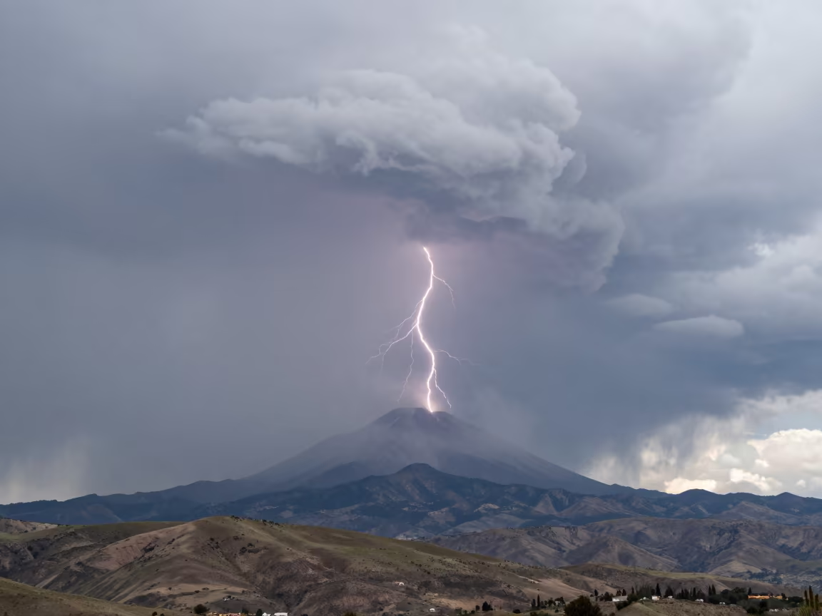 Lightning Strikes Volcanic Ash Plume Near Cusco in over a horizon of stacked thunderheads near Cusco