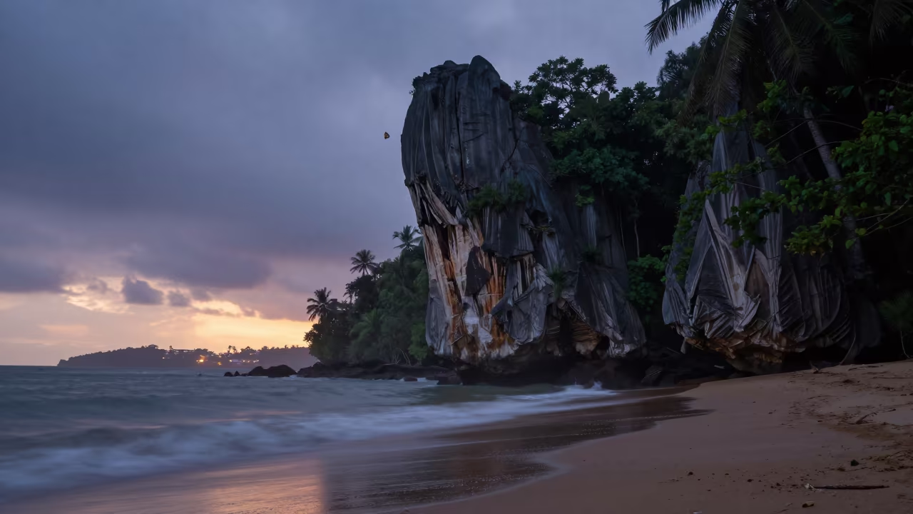 Limestone Karst Tower Rising from Jungle Mist at Twilight in along a wave-cut shoreline near Walled City, Cartagena