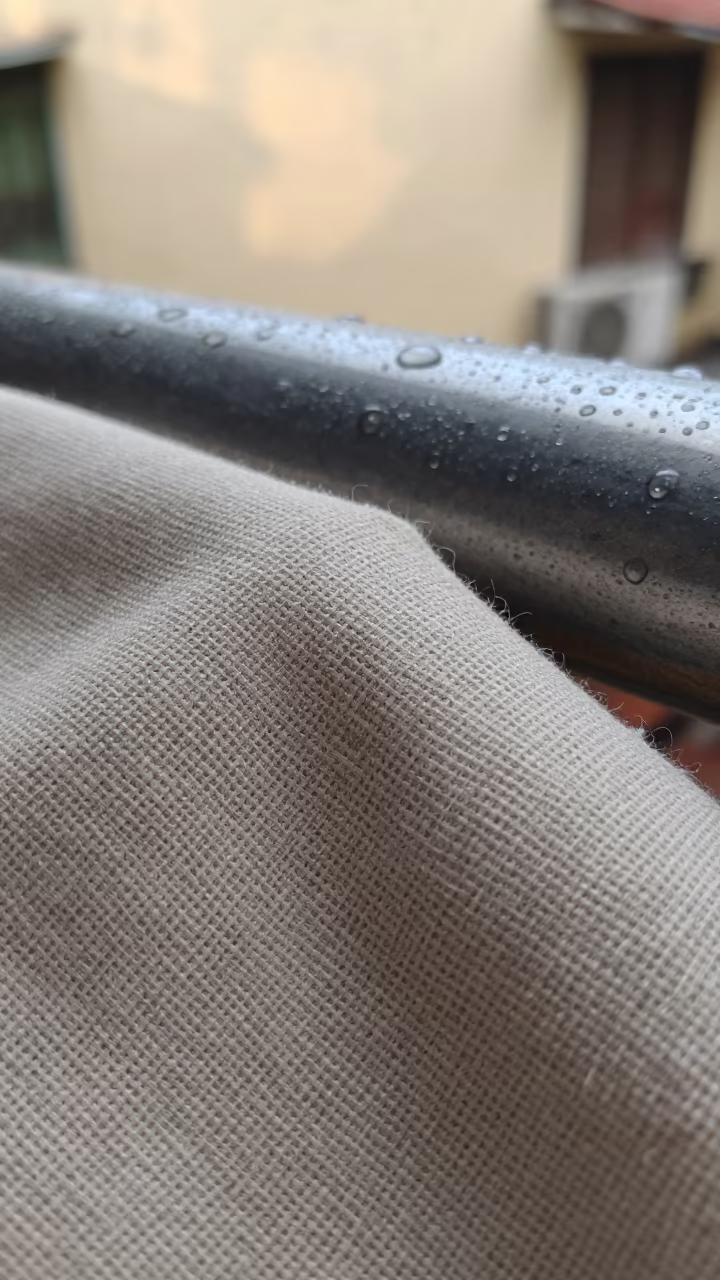 Linen Canvas Weave Under Magnification on Rain Beads in across a rain-beaded metal surface in French Quarter, Hanoi