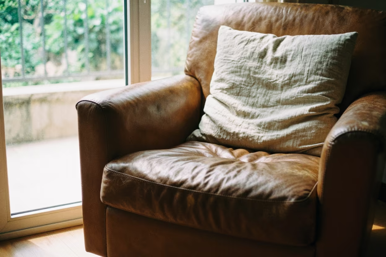Linen Cushion on Worn Leather Armchair in on a worn leather armchair near Qingdao