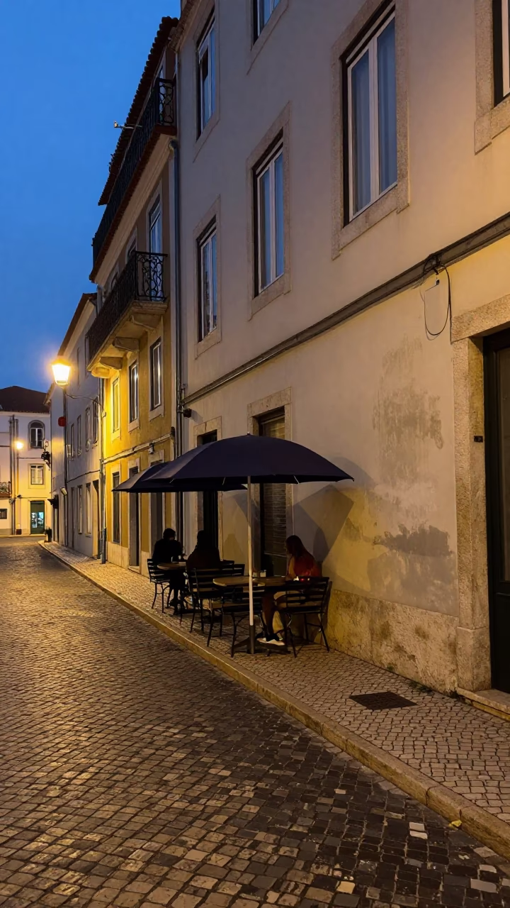 Lisbon Portugal Early Evening Street Scene with Umbrellas and Stone Walls in in Lisbon, Portugal
