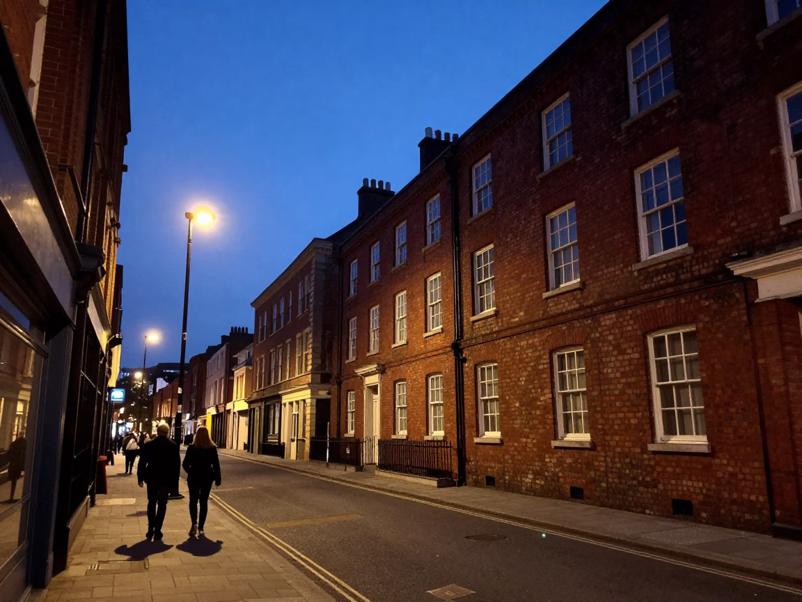 Liverpool indigo twilight street scene with vintage red brick architecture and evening pedestrians in in Liverpool, United Kingdom