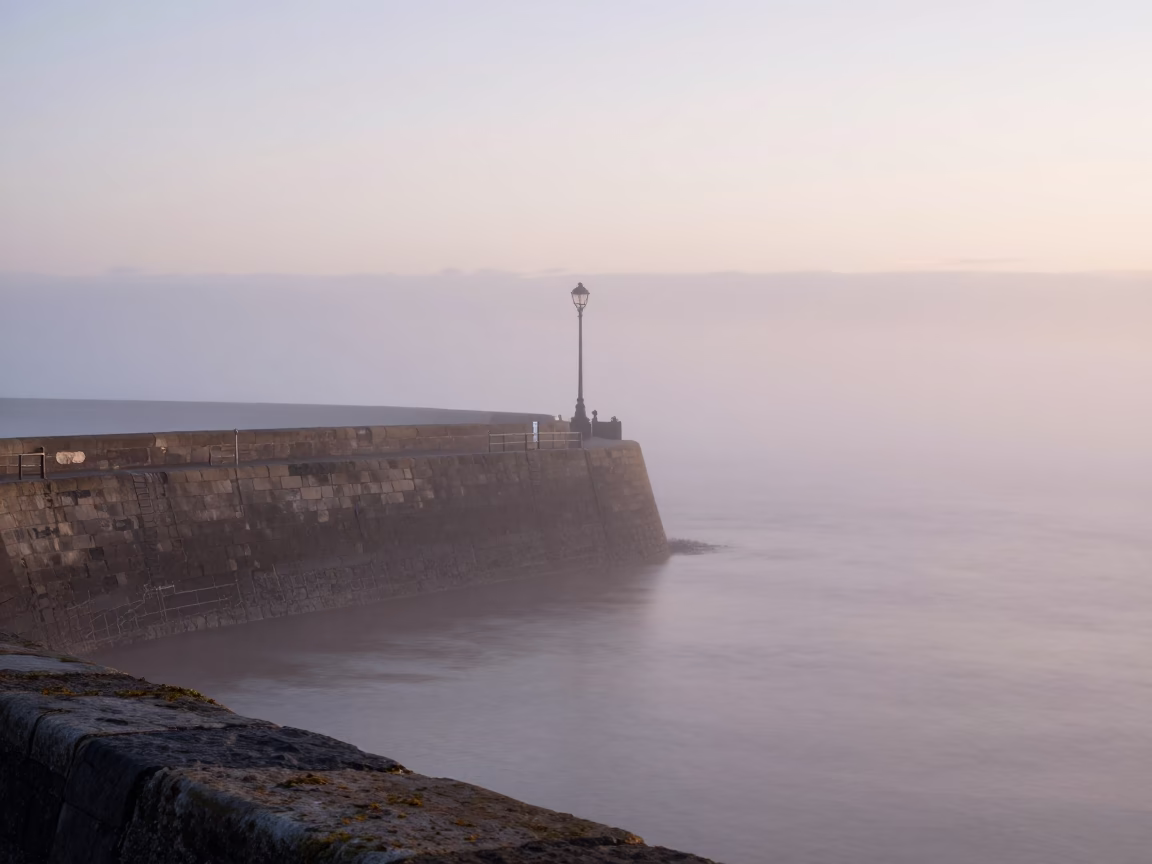 Liverpool Sea Fog Crawling Over Breakwater at Nautical Dawn in in Liverpool, United Kingdom