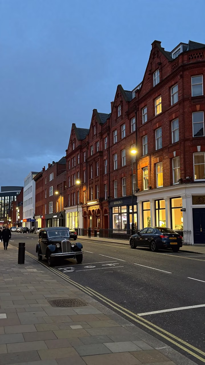 Liverpool Street Scene at Dusk with Vintage Car and Brick Buildings in in Liverpool, United Kingdom