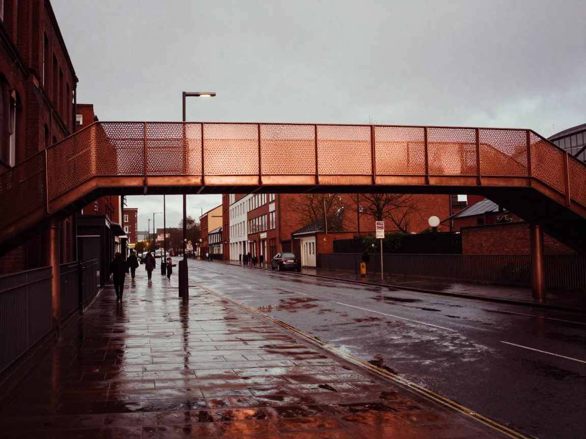 Liverpool Street Scene Before Dusk Pedestrian Overpass Perforated Metal and Wet Footsteps in in Liverpool, United Kingdom