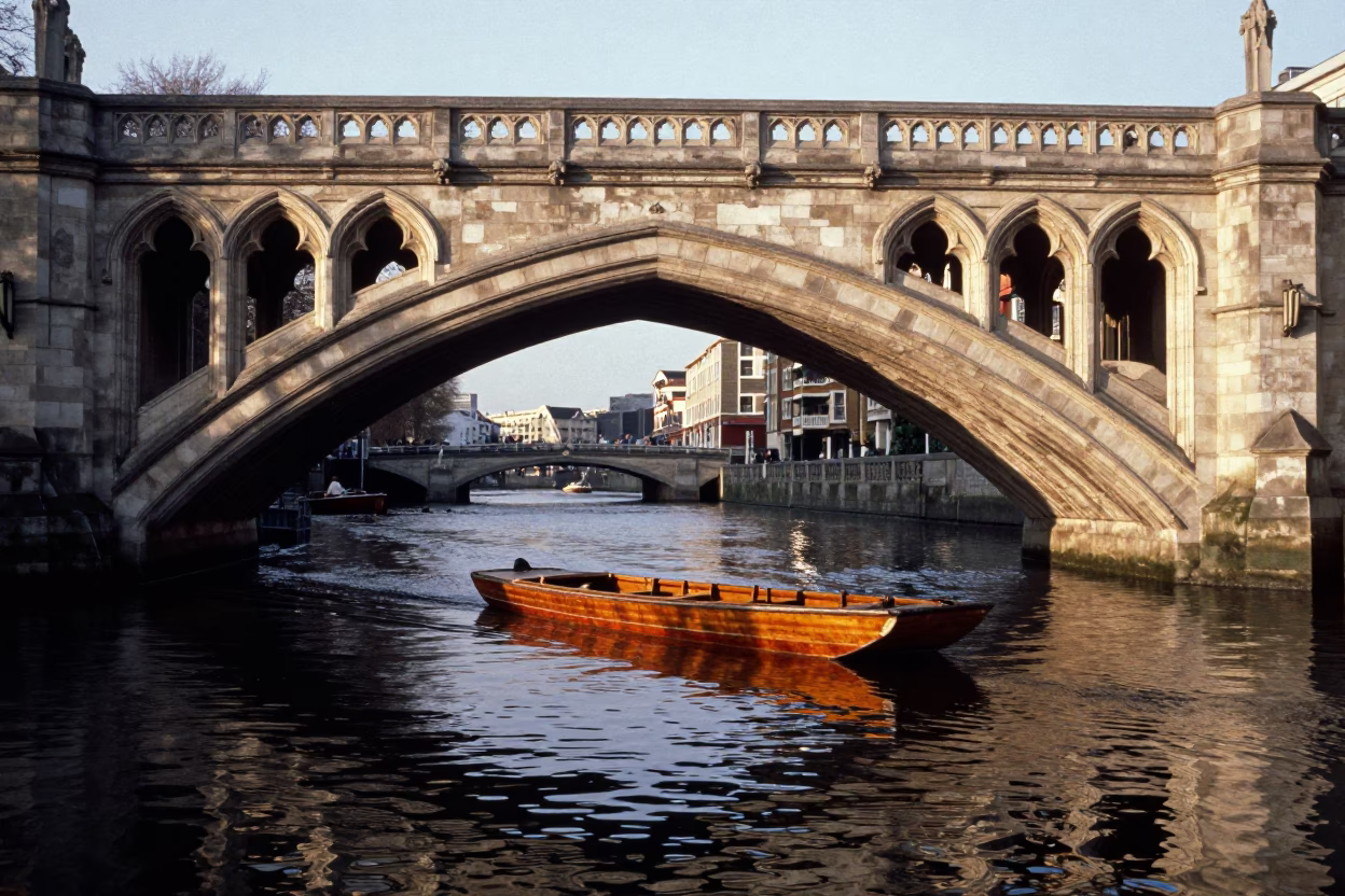 London Late Afternoon Punt Gliding Under Gothic Stone Bridge Along Black Tidal Channel in in London, United Kingdom