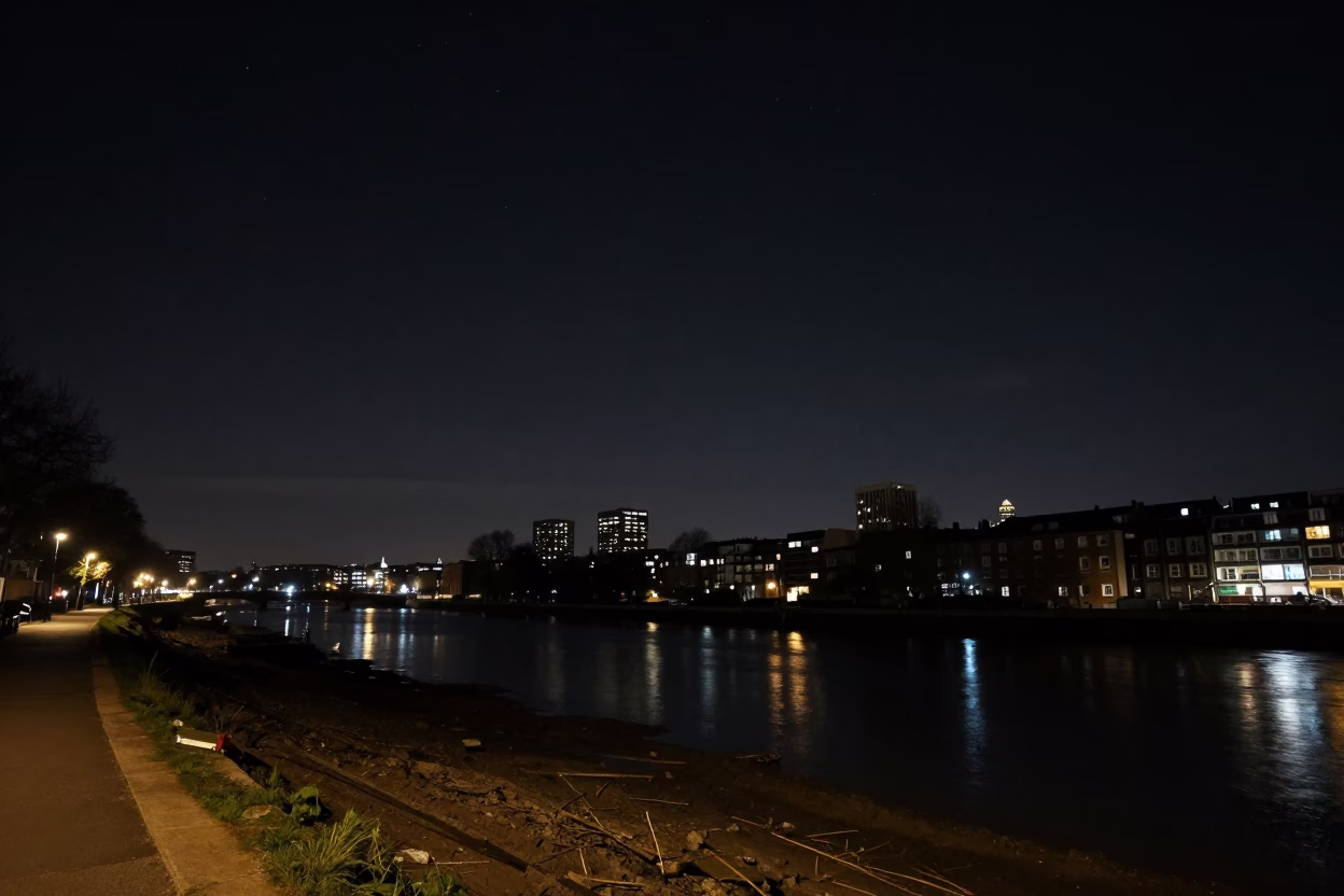 London Night Sky and Canal Scene with Distant Urban Lights and Muddy Bank in in London, United Kingdom