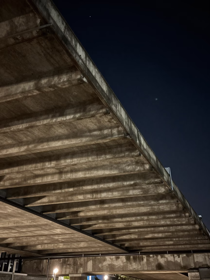 London Night Sky Under Flyover Underside with Striped Shadows from Passing Traffic in in London, United Kingdom