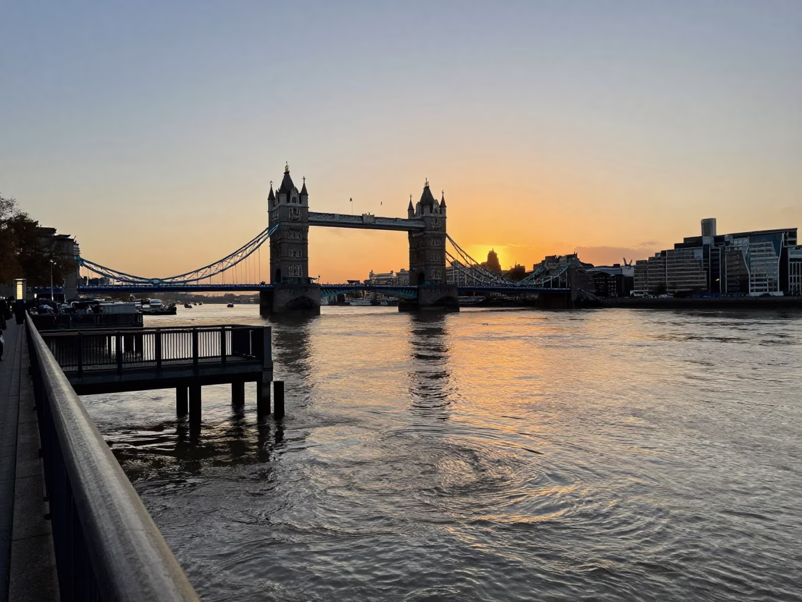 London Thames Sunset View from Tower Bridge Pier with Muddy Floodwater and Urban Skyline in in London, United Kingdom