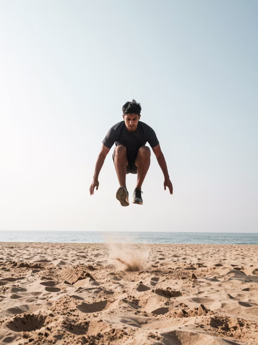 Long Jumper Mid Flight Over Winter Beach in along a beach near Gujrat