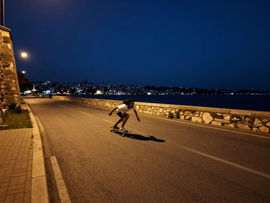 Longboarder Carving Fener Harbor at Midnight in at a harbor quay near Fener, Istanbul