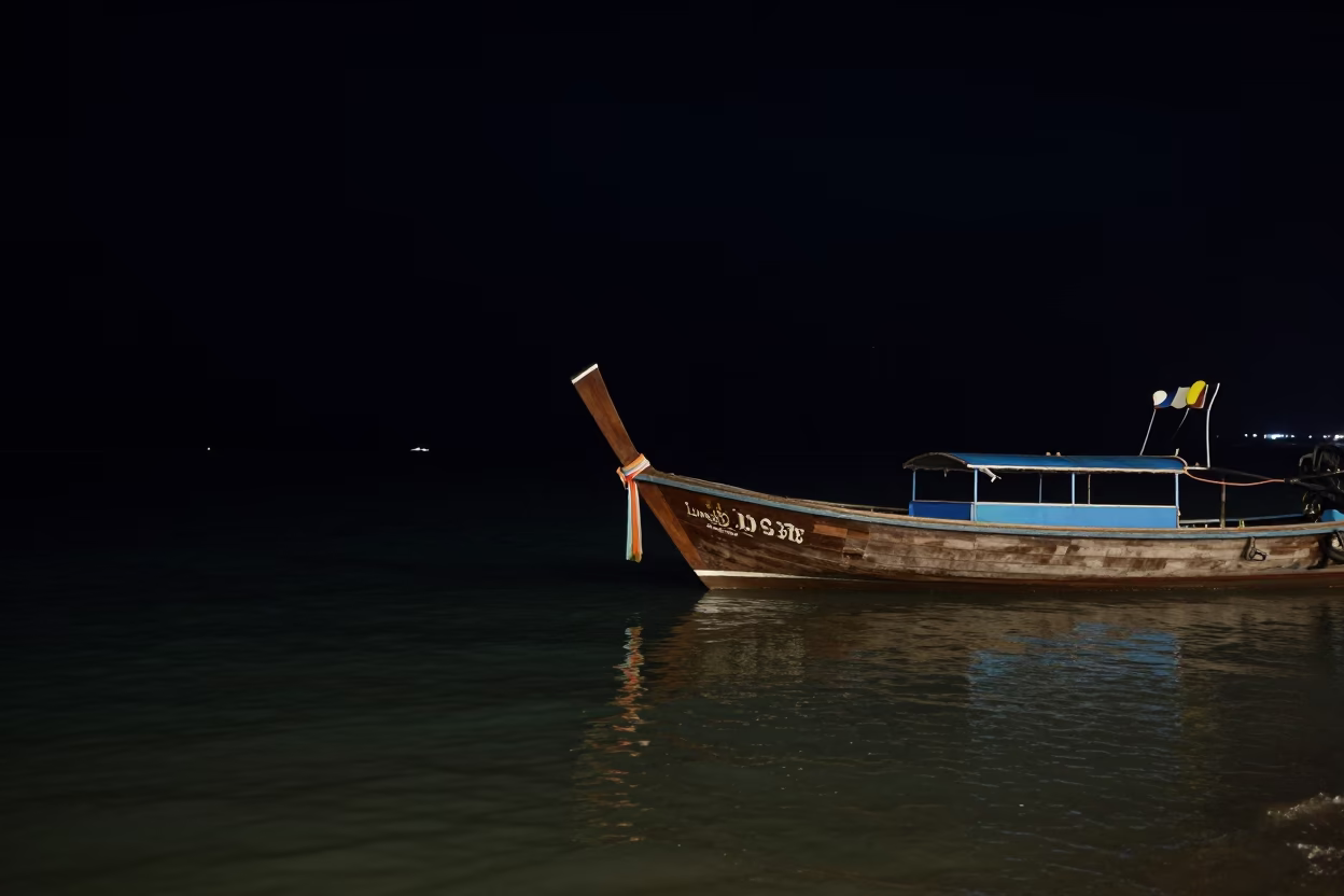 Longtail Boat Docked Under Deep Night Sky in Phuket Thailand Lagoon in in Phuket, Thailand