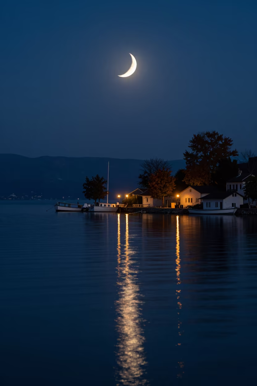 Lunar Crescent Reflected in Bosnia Fjord Twilight in beside a lantern-dotted harbor in Bosnia and Herzegovina