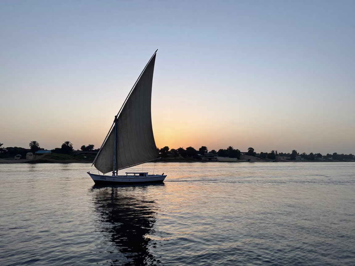 Luxor Egypt First Light Dawn Nile River Dhow Sailboat Silhouette in in Luxor, Egypt
