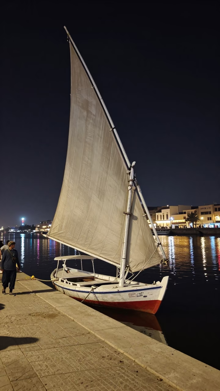 Luxor Egypt Night Street Scene With Traditional Sailboat And Signal Gantry in in Luxor, Egypt