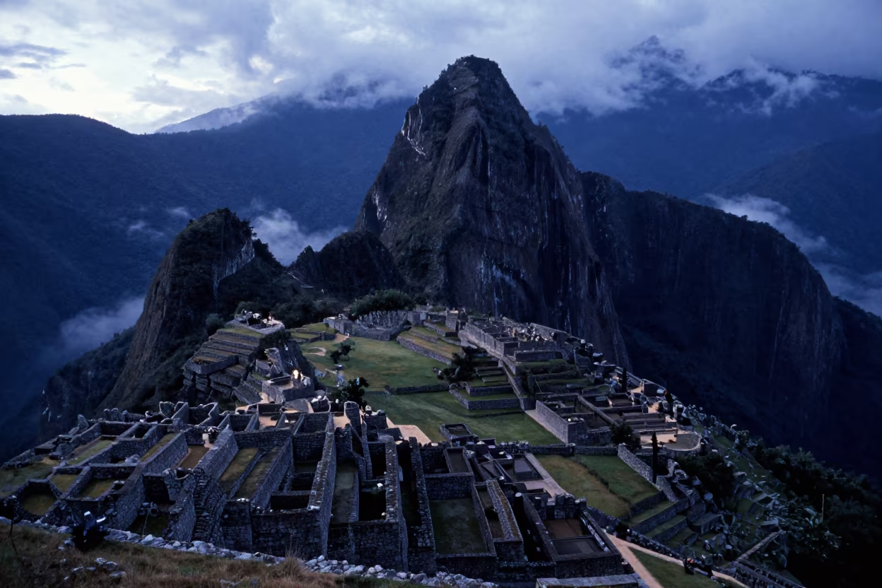 Machu Picchu terraces above cloud forest at twilight in across a wide valley floor near Aurangabad