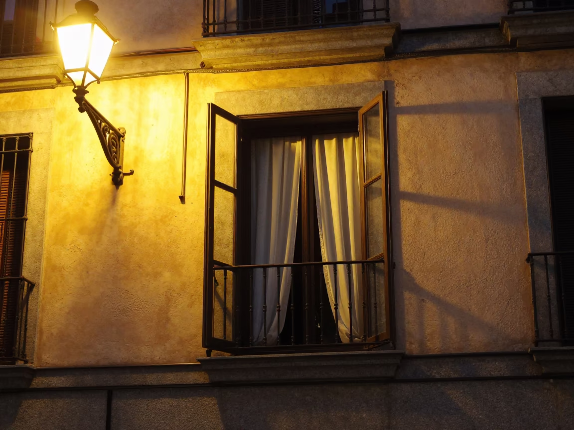 Madrid midnight street scene with open window and curtain lifting in in Madrid, Spain