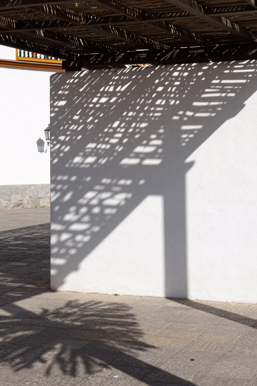 Madrid Plaza Sunlight Casts Wicker Shadows on White Plaster Walls in in Madrid, Spain
