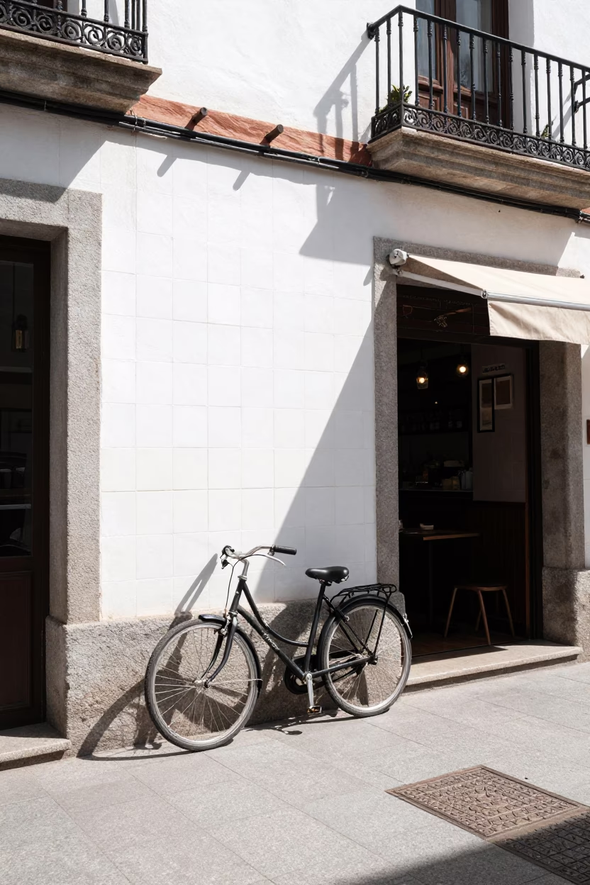 Madrid Spain Midday Street Scene with Bicycle Leaning Against Cafe and Peg Rails in in Madrid, Spain