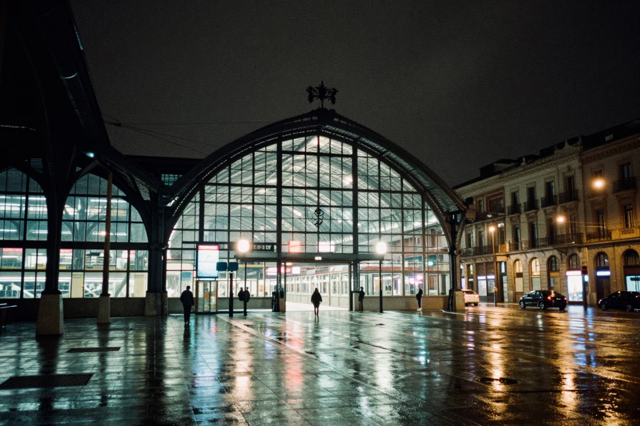Madrid Spain Night Street Scene Glass Steel Train Station Arched Roof Rain Reflections in in Madrid, Spain