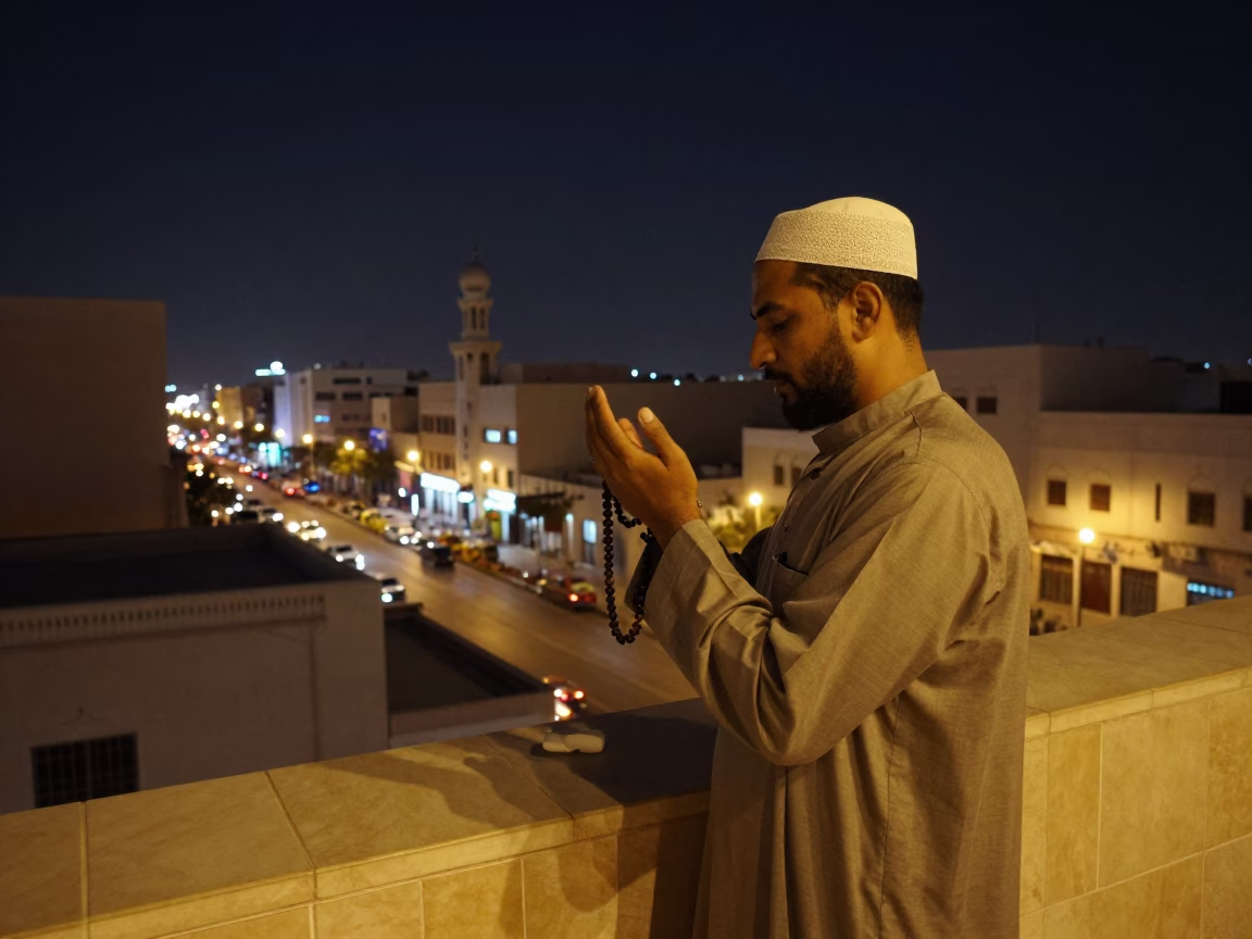 Man Praying after dark in Muscat in in Muscat, Oman