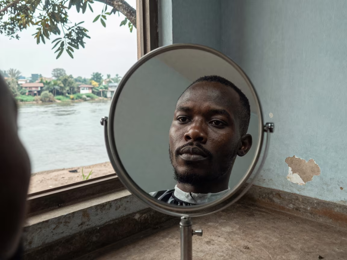 Man's Face Reflected in Barbershop Mirror in near a riverside landing in Lubumbashi