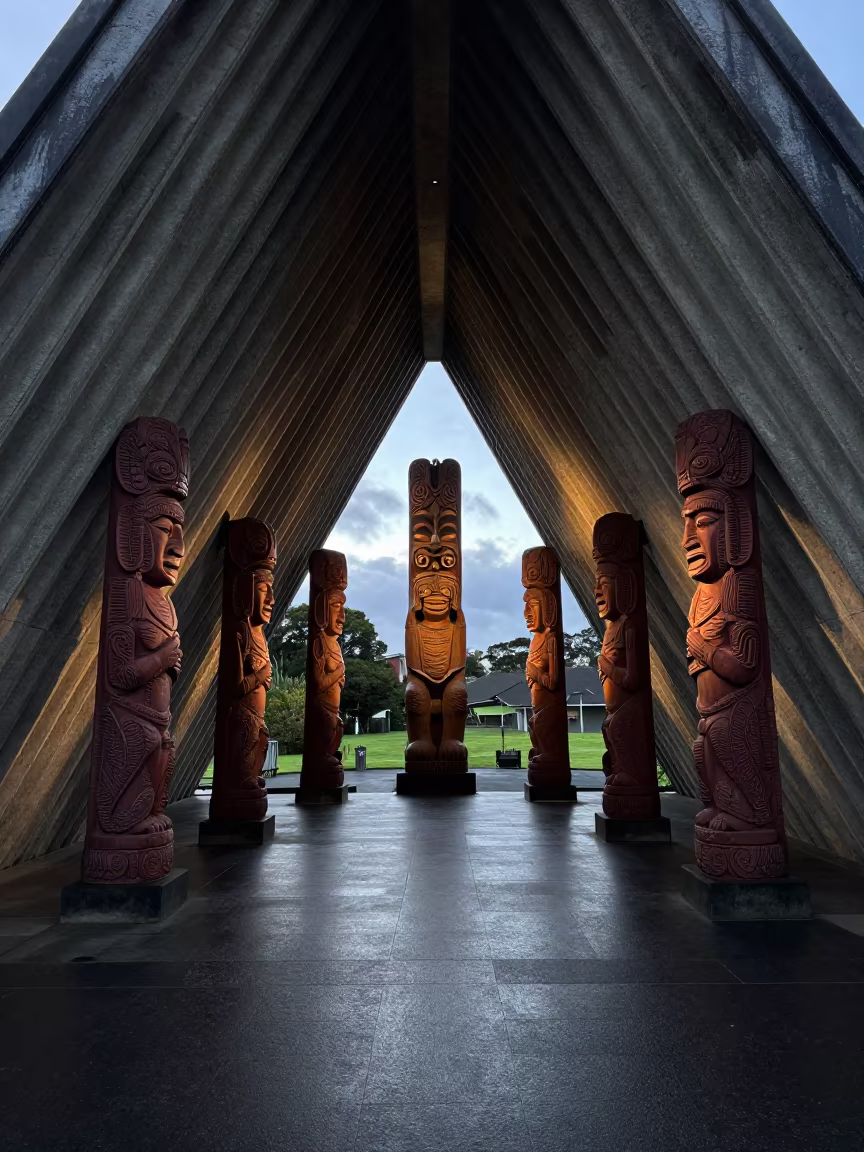 Maori Meeting House Carvings in Winter Lobby in inside a ribbed concrete lobby near Auckland
