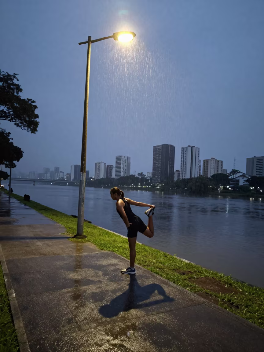 Marathon Runner Stretching Under Streetlamp Dawn in by a riverbank near São Paulo