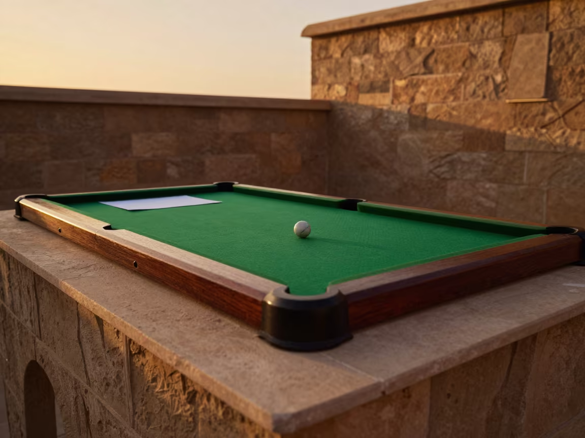 Marble on Green Felt at Sunset in Katsina in on a stone ledge in Katsina
