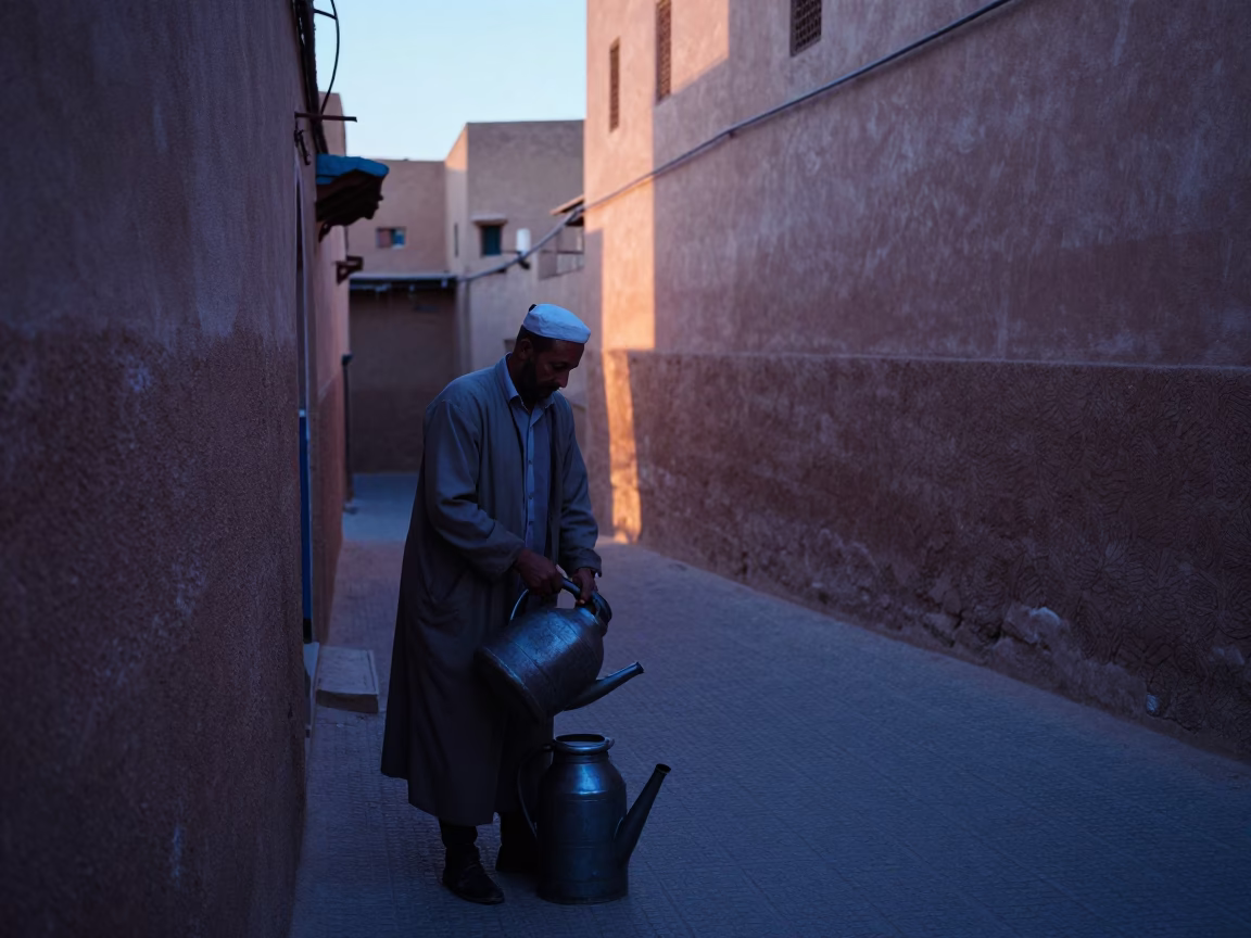 Marrakech Souk Vendor Arranging Watering Jugs Before Dawn in Morocco in in Marrakech, Morocco