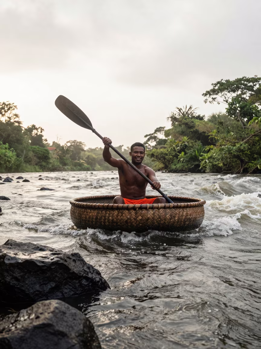 Mauritian Coracle Fisherman Paddling Rapids in across a remote ferry crossing in Mauritius