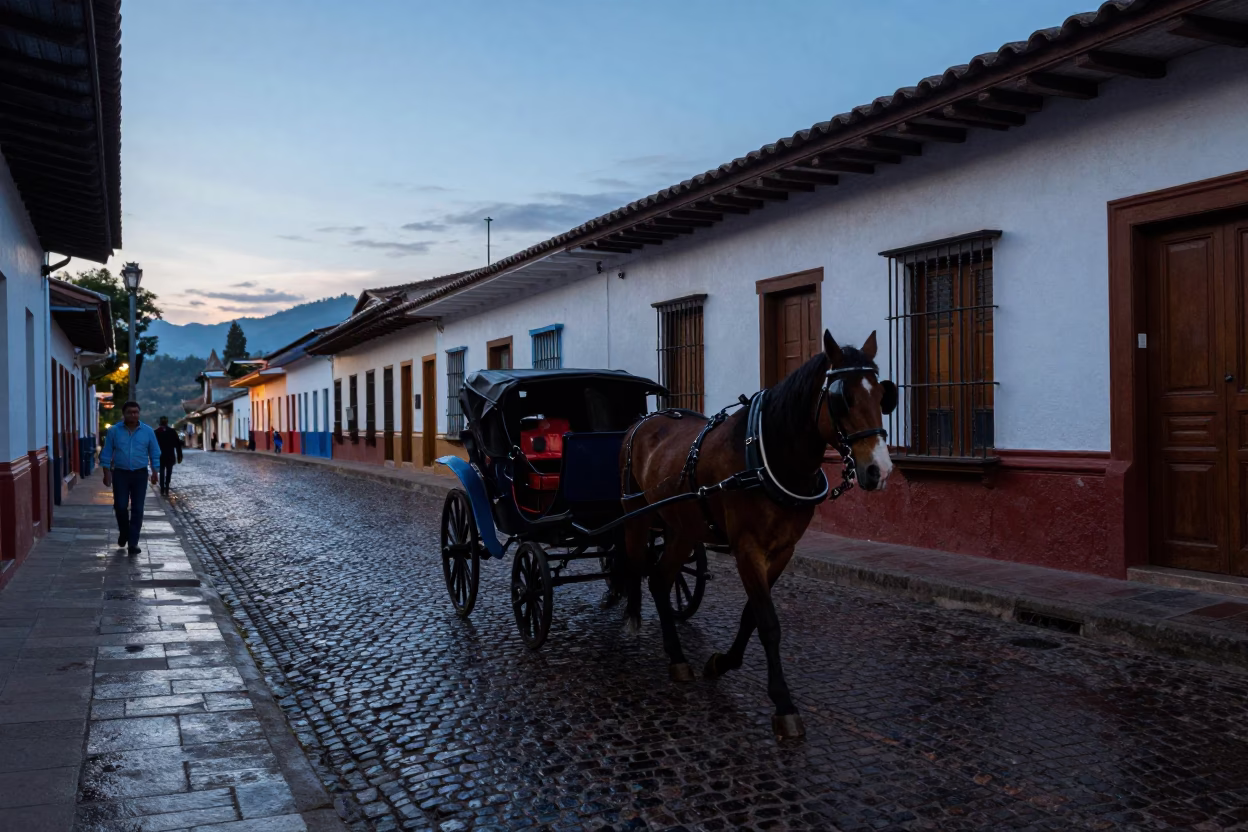 Medellin Colombia street scene at blue hour with horse drawn carriage and cobblestones in in Medellin, Colombia