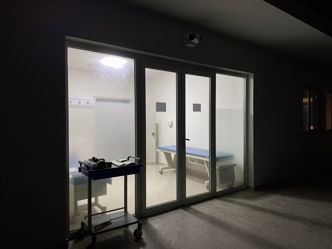 Medical Cart Rolling Past Glass at Night in inside a clinic exam room in Mashhad